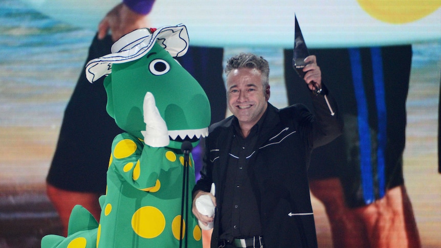 The Wiggles' Dorothy the Dinosaur and Paul Field accept their best children's album award at the ARIAs.
