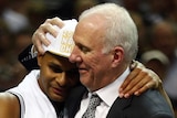 Patty Mills congratulated by Gregg Popovich