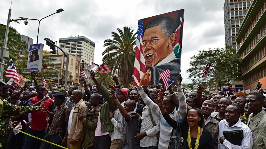 Crowds of Kenyans cheer and hold a painting representing US President Barack Obama in Nairobi