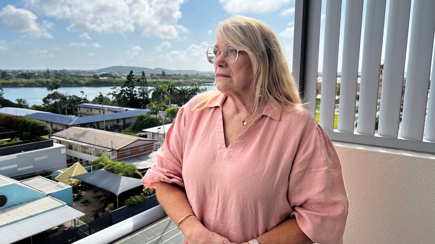 Vicki Blackburn stands on her balcony overlooking Mackay. 