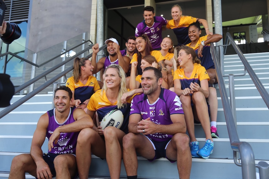 Lightning players wear tops featuring canary yellow and a deep purple, Storm wear purple training tops. Sitting on stairs.
