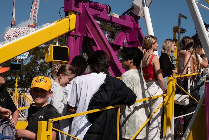 Young people line up for a thrill ride at the Perth Royal Show.