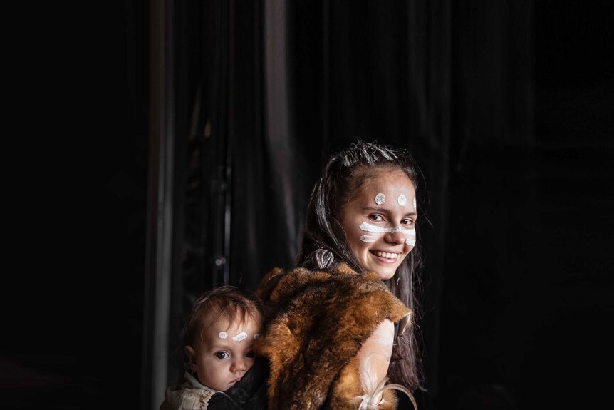 Colour photo of Sara-Rae Hooper and daughter Jahlie Newton of Wagana Dancers side of stage at Dance Rites 2018.