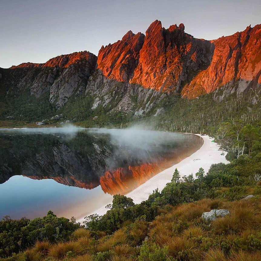 The reflection of mountains and a lake at Lake Rhona in Tasmania's south west.