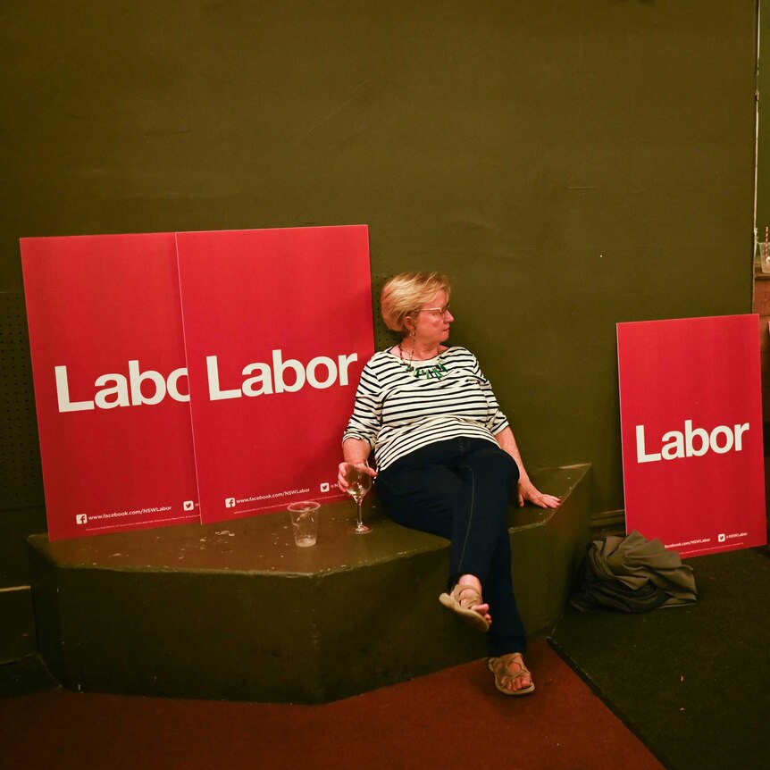 A Labor party supporter is seen in an empty room on election night.