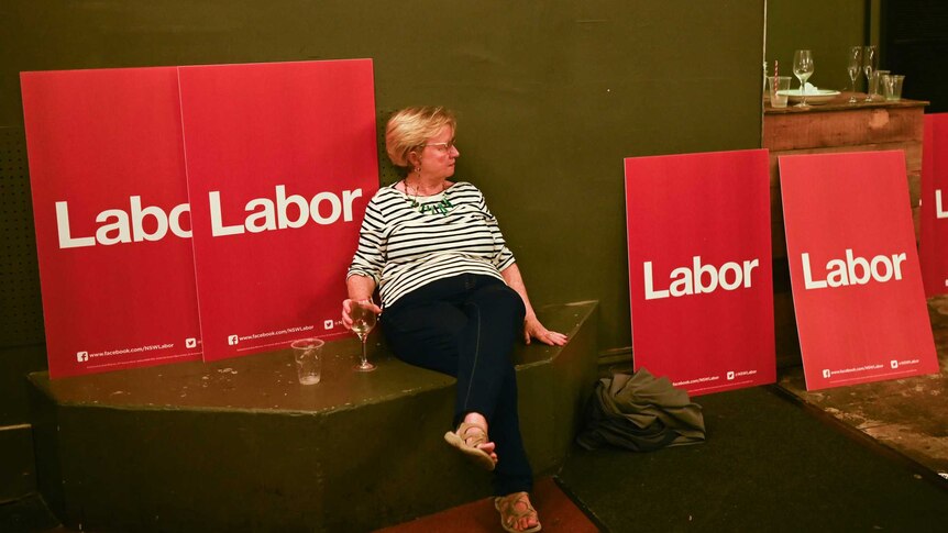 A Labor party supporter is seen in an empty room on election night.