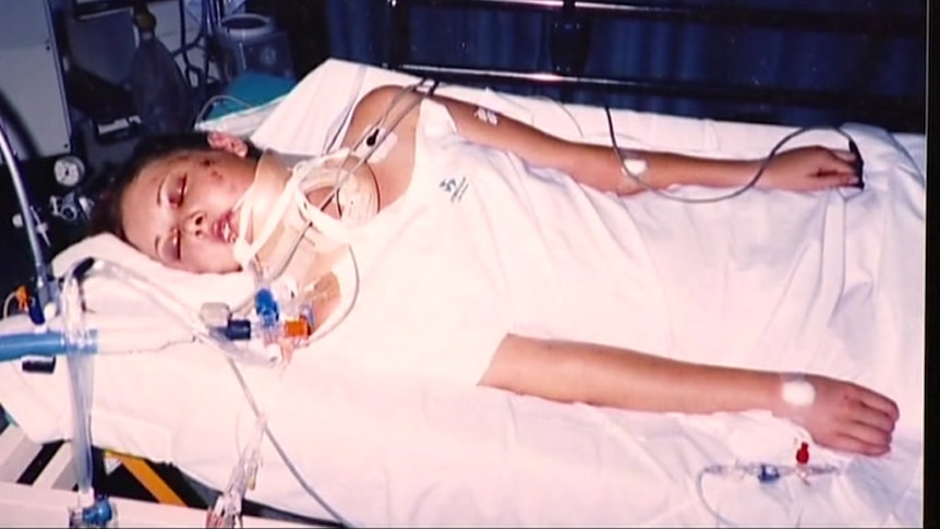 Anj Barker lying in a hospital bed in a coma as a 16-year-old.