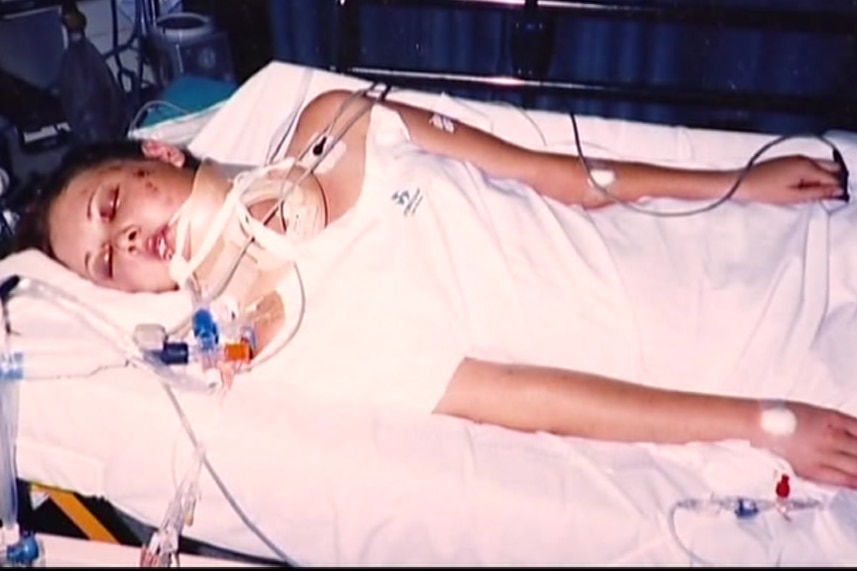 Anj Barker lying in a hospital bed in a coma as a 16-year-old.