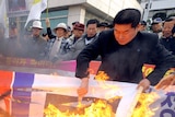 Activists in Seoul burn a North Korean flag and portraits of Kim Jong-il and Kim Jong-un.