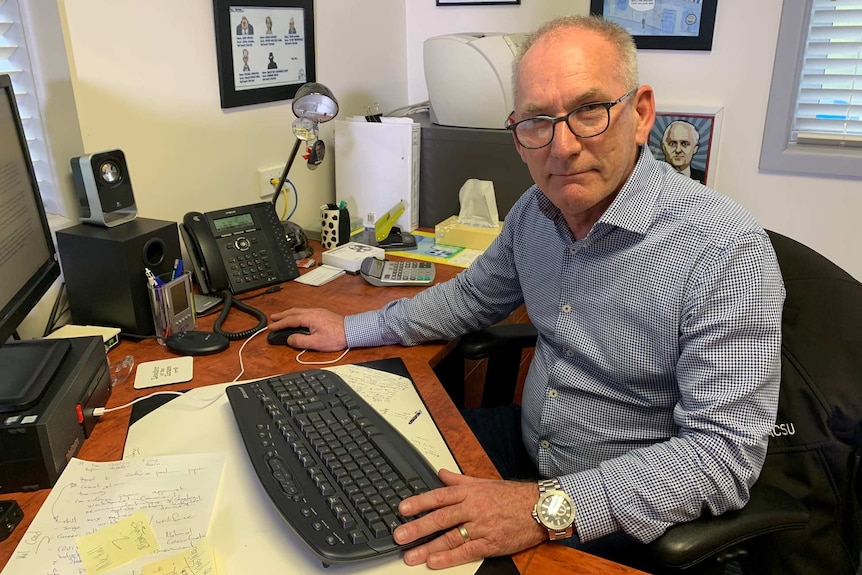 Tim Jacobson from HACSU at his desk.