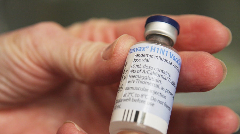 A man holds a swine flu vaccine.