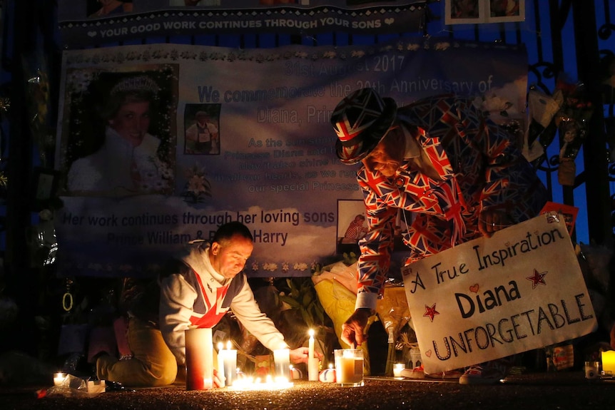 Tributes, candles and flowers are laid by royal fans for the late Diana. It is early morning in front of Kensington Palace.