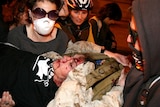 The Occupy Oakland protesters carry away Scott Olsen after he was hit by a tear gas canister