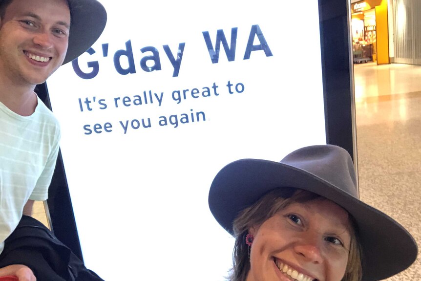 Matt Bamford and Sophia O'Rourke stand in front of a welcome to WA sign.