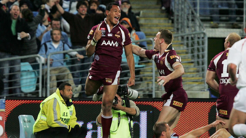 Queensland's Israel Folau jumps in the air to celebrate a State of Origin try on July 2, 2008.