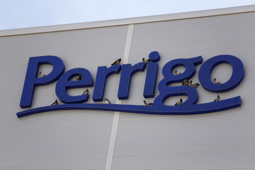 Large blue letters spelling the company name Perrigo on the side of the building