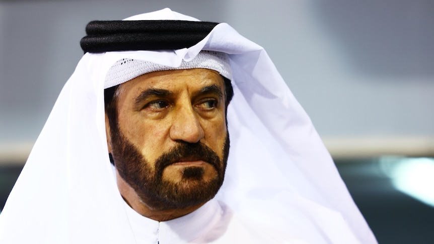 Mohammed ben Sulayem, in traditional Arab garments, looking on during a night session of F1.