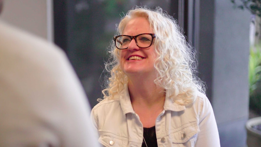 Elizabeth Beales sitting down smiling