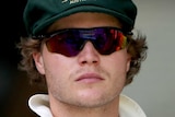 Will Pucovski wears a baggy green cap and sunglasses