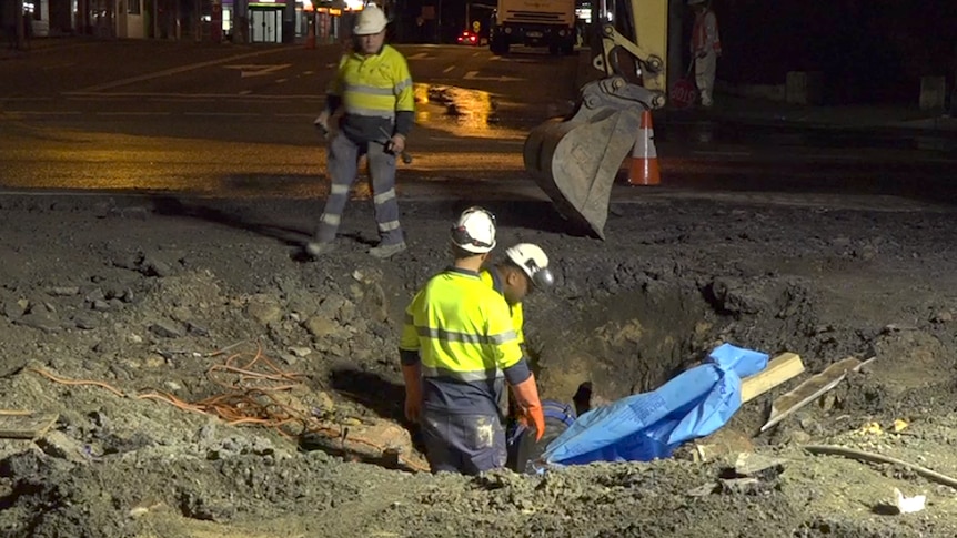 Workers in Caringbah attempting to fill the hole last night