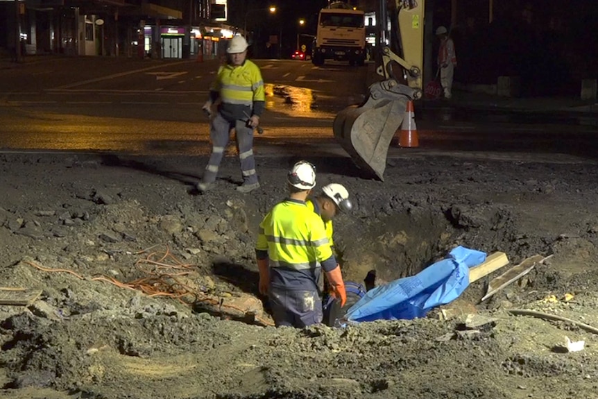 Workers in Caringbah attempting to fill the hole last night