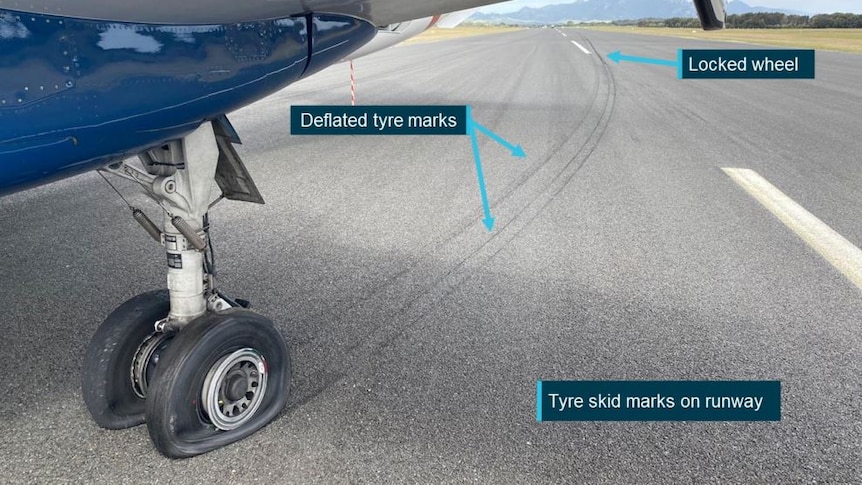 A delated tire on a plan and tyre marks