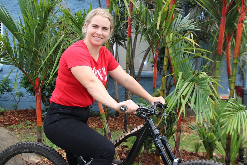 Tracey Hannah on her bike relaxing at her home in Cairns