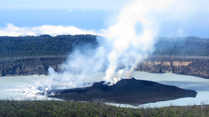 Steam rises from the volcanic cone that is surrounded by Lake Vui