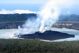 Steam rises from the volcanic cone that is surrounded by Lake Vui