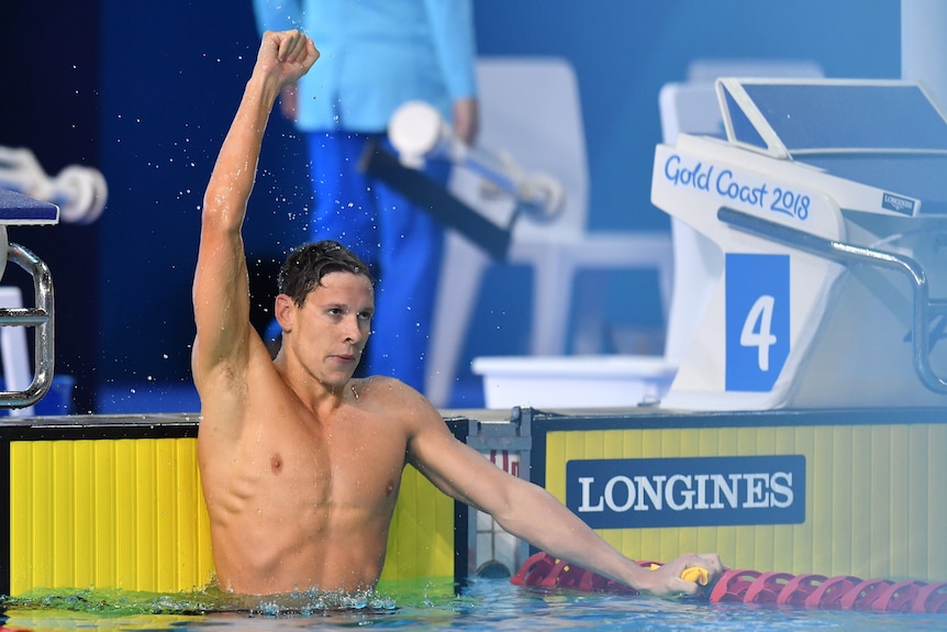 Mitch Larkin with his fist in the air after finishing race.