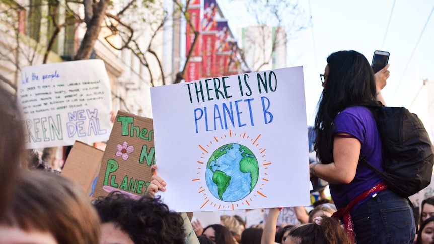 Protester holding sign saying 'there is no planet b'