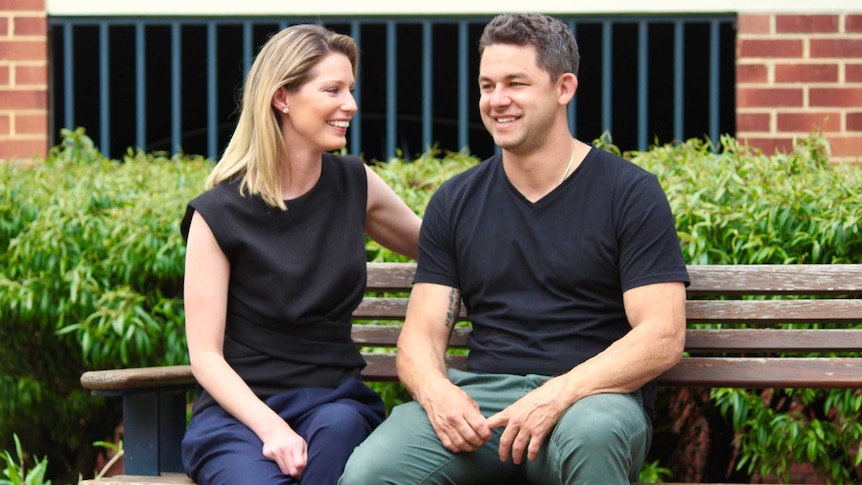 Rebecca and Phil Britten sitting on a park bench.