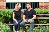 Rebecca and Phil Britten sitting on a park bench.