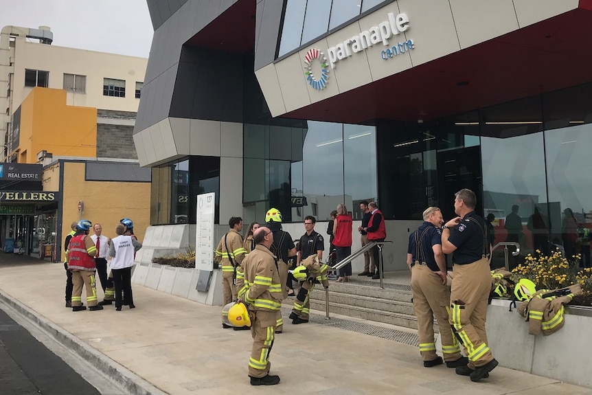 Firefighters outside a building.