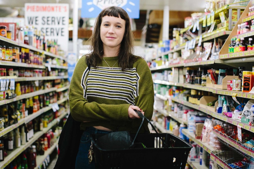 Young woman Cat stands in the middle of the aisle