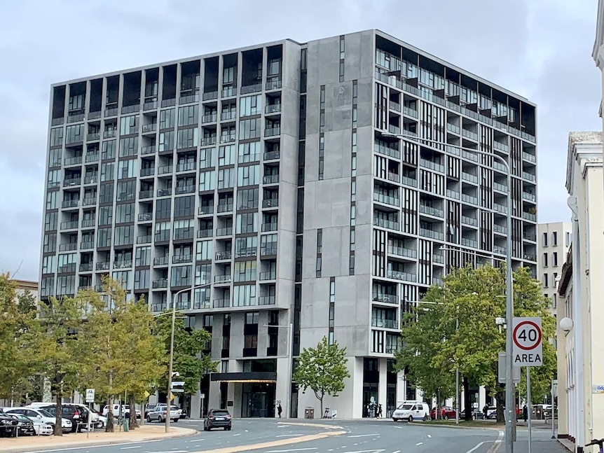 A large apartment building as seen from the street.