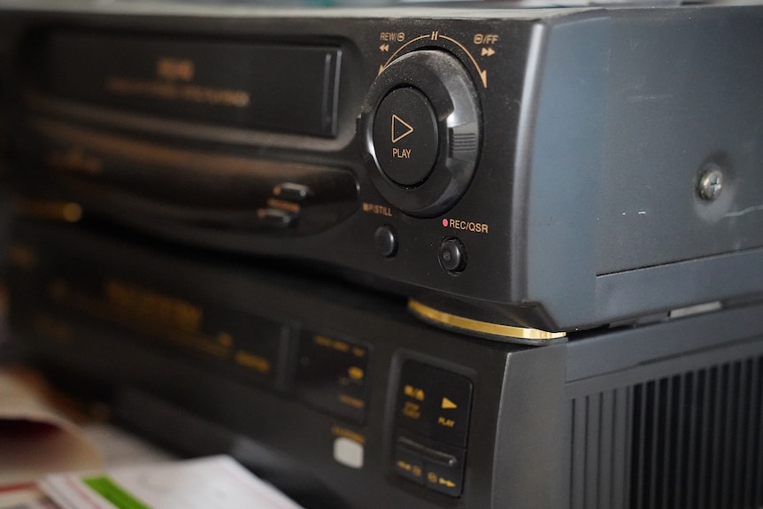 A close up of a black VHS tape player