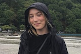 Australian woman Madison Lyden wears a black raincoat.