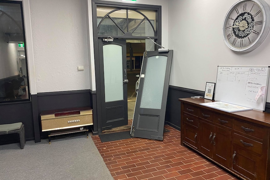 A large grey door in a historic Kalgoorlie hotel was busted off its hinges by a group of people. 