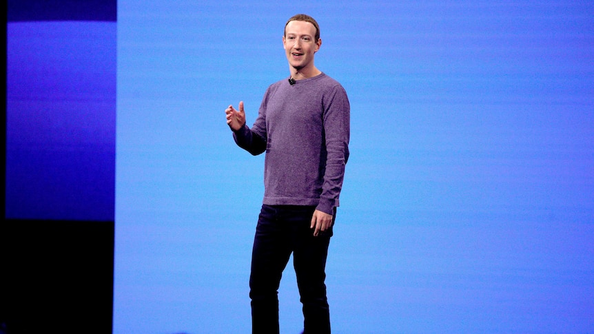 Mark Zuckerberg stands and gives a speech at a conference