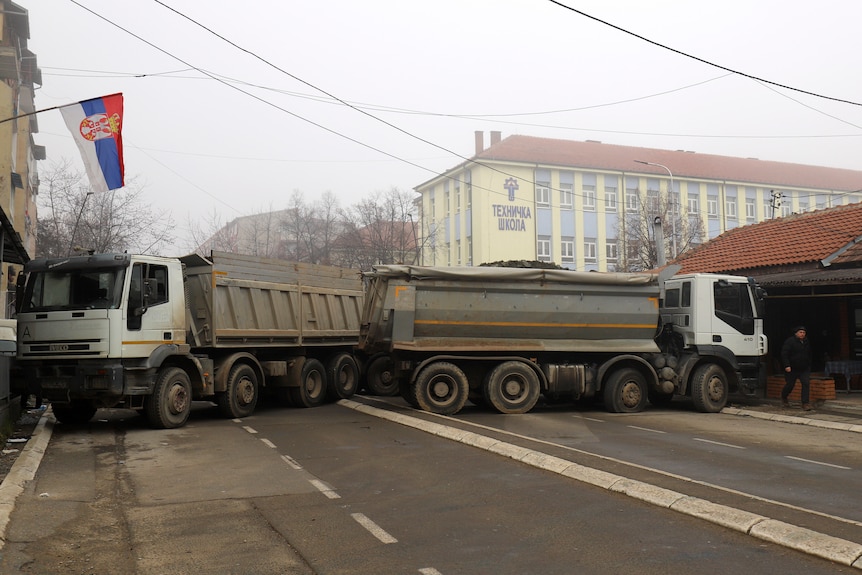 two trucks blocking a road