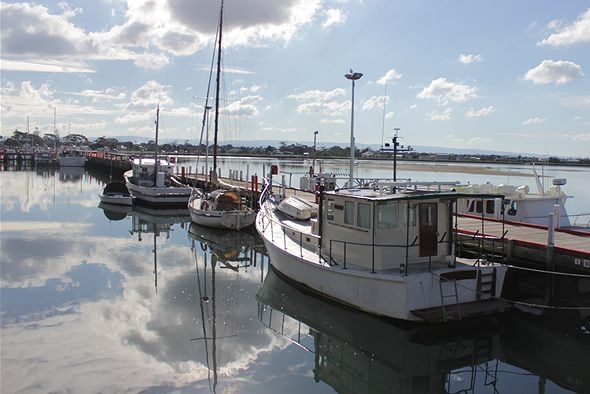 Fishing boats tied to a jetty.