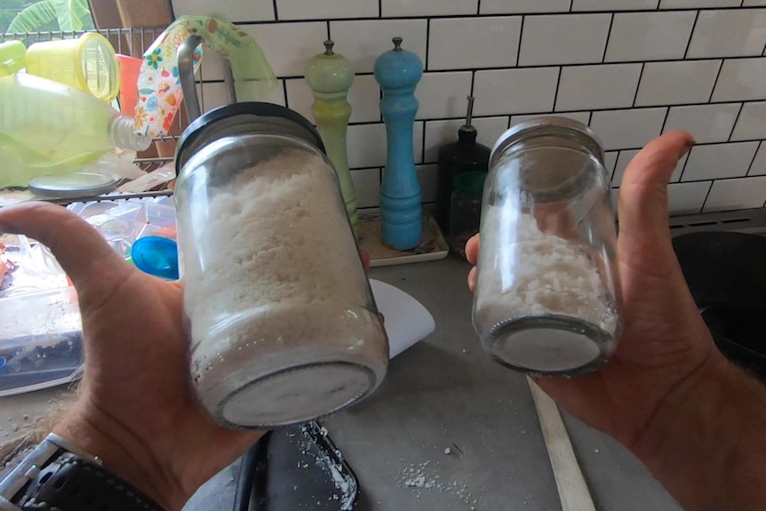 Hands holding a jar of sea salt in each.