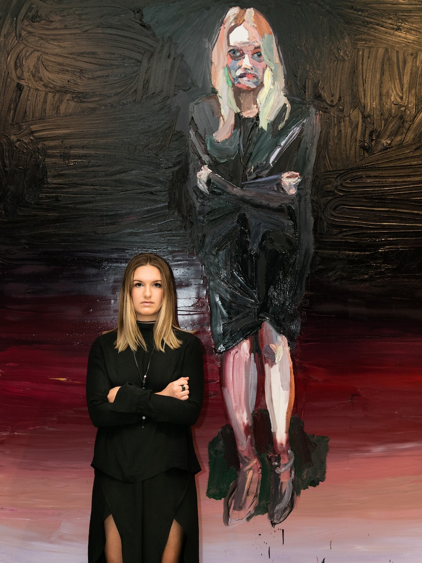 Elle-Lou Diddams with her portrait by Ben Quilty at the Australian War Memorial