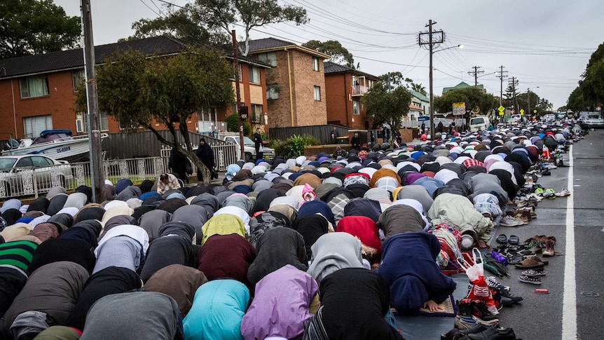 Muslims pray in the street outside Lakemba mosque during the festival of Eid al-Fitr.