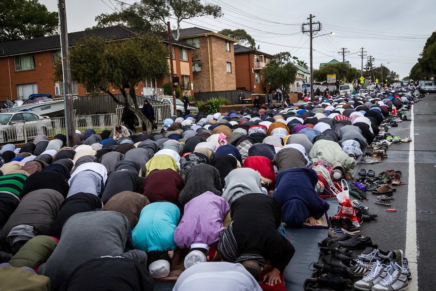 Muslims pray in the street outside Lakemba mosque during the festival of Eid al-Fitr.