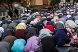 Muslims pray in the street outside Lakemba mosque during the festival of Eid al-Fitr.