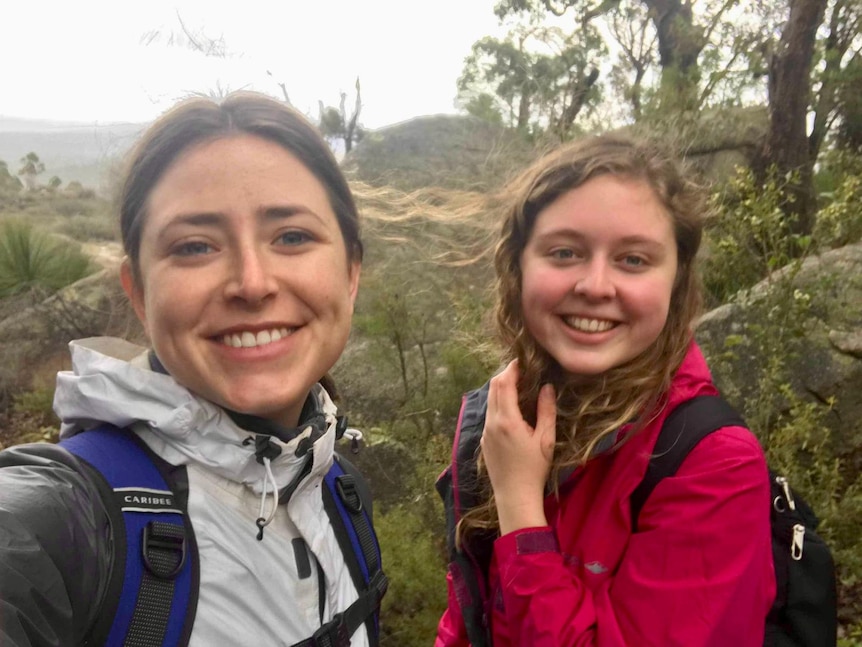 Two women take a selfie in the Australian bush.