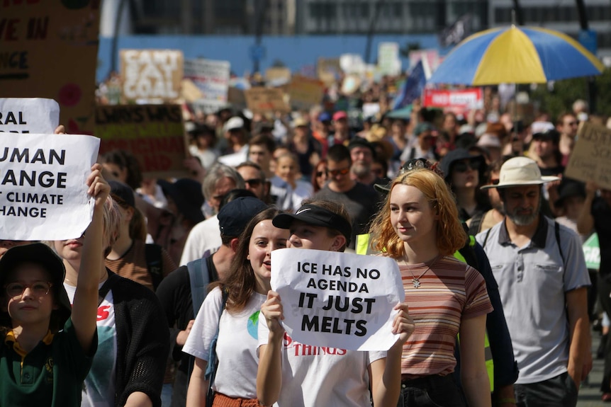 Crowds walk through Brisbane city streets