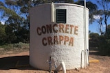 Water tank done up to be a toilet with Concrete Crappa written on it